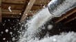 © INT888 - close up of cellulose insulation being blown into space, showcasing fine particles dispersing in air. This process highlights effectiveness of cellulose insulation for energy efficiency