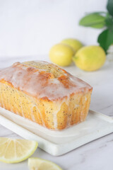 Wall Mural - freshly baked homemade lemon poppy seed pound cake on white ceramic tray.