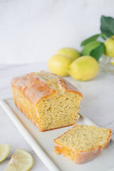 Wall Mural - freshly baked homemade lemon poppy seed pound cake on white ceramic tray.