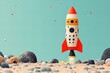 © EvgeniiasArt - Colorful toy rocket launching on sandy beach with blue sky background