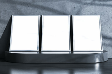 Aufkleber - Three empty white frames on pedestal. Gray concrete wall background. Mock up concept. 3D Rendering.