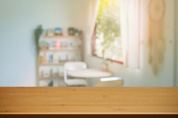 Wooden top table with abstract blur interior coffee shop or cafe for background. Restaurant interior banner, Hospital and clinic blurry. Blurred windows green on outdoor and view of light living room.