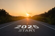 © Woraphon - Happy new year 2025,2025 symbolizes the start of the new year. The letter start new year 2025 on the road in the nature route roadway sunset tree environment ecology greenery wallpaper concept.