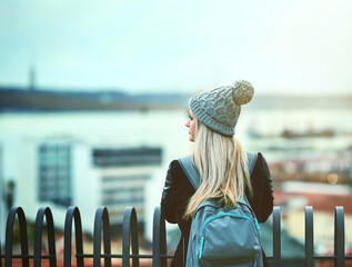 View, college student and back of girl in city on outdoor travel adventure or bridge in London. Winter fashion, urban tourism or woman thinking of vacation or holiday for sightseeing trip in England