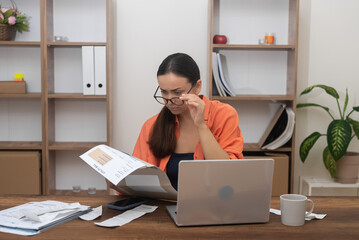 worried lady, homebound, gazes at a utility bill, her mind preoccupied with mortgage payment concerns and mounting debt