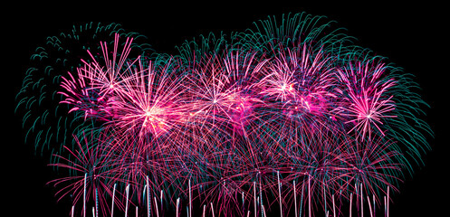 Colorful celebration fireworks isolated on a black sky background.