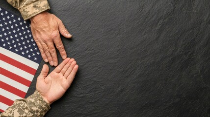 Hands reaching out on a dark surface, alongside an American flag, symbolizing unity and support.