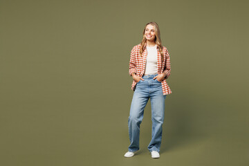 Poster - Full body young smiling happy cheerful fun woman she wear red shirt white t-shirt casual clothes look aside on area mockup isolated on plain pastel green background studio portrait. Lifestyle concept.