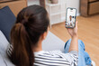 © olga_demina - Telehealth appointment with a doctor discussing medication over a smartphone video call.