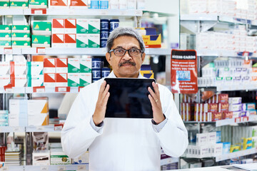 Wall Mural - Pharmacy, tablet screen and portrait with mature man in store for medicine, mockup and healthcare. Medical, insurance and online prescription with pharmacist in clinic for drugstore and dispensary