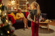 © bernardbodo - Little girl hiding a Christmas present for her grandparents