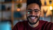 © Shutter2U - Smiling man with glasses and beard looking at camera.