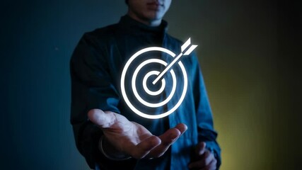 Poster - A person holding a glowing target symbol representing goals and focus.