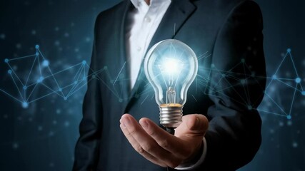 Poster - A businessman holds a glowing light bulb, symbolizing innovation and ideas.