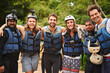 © peopleimages.com - People, portrait and group hug for rafting, outdoor and diversity in water sports on vacation. Friends, weekend trip and adventure together in nature, fitness and life jackets for safety in exercise