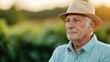 © Intelligent Horizons - Retired elderly man in casual attire relaxing and sipping a cup of coffee while sitting in a quiet garden setting surrounded by a peaceful blurred natural environment and soft morning sunlight