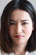 © 9nong - Angry Asian woman with irritating expression, upset unhappy young adult real woman staring at you with frustrated mood, upset emotion