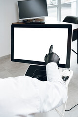 Poster - A person in gloves interacting with a touchscreen display in a modern office environment