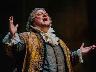 male opera singer sings emotionally in theater performance