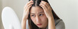 © Pormezz - Young woman worrying about her thin hair and hair fall