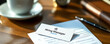 © JJ1990 - A business card with the words 'Hiring Manager' on it sits on a desk with a pen and a form.