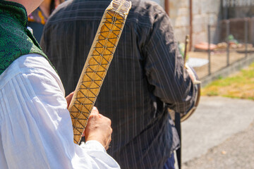 a male musician dressed in traditional costume from Galicia, playing a typical percussion instrument called pandeiro. Spain