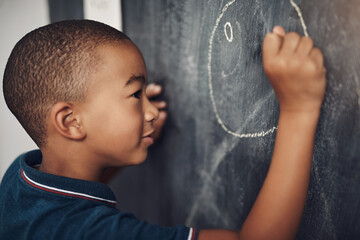 Chalkboard, circle and education with boy student in classroom of school for growth or learning. Blackboard, development and drawing with child in lesson for academic knowledge or scholarship