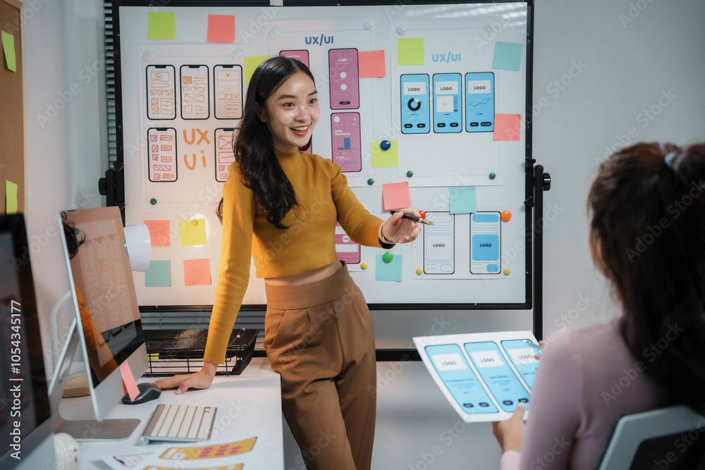 Two female ux ui designers are discussing mobile app interface design ...