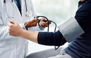 Man, hands or doctor with pump for blood pressure, checkup or hypertension exam at hospital. Closeup, male person or medical cardiologist with tool or equipment for artery or cardiac result at clinic