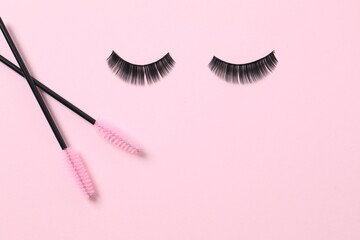 Eyelash extension brushes on a color background. Brush for combing extended and false eyelashes. Brush for straightening eyelashes and eyebrows