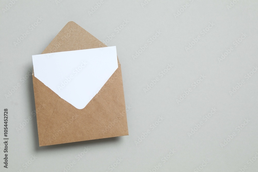 Empty Envelope Card Сraft paper envelope and white card on gray background with empty space ...