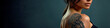 © zakiroff - Captivating tattoo art on woman's shoulder, elegant portrait with dark background, showcasing beauty and style, copy space concept. Banner