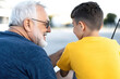 © Konstiantyn Zap - Grandfather and grandson bonding during a joyful fishing trip day outdoors