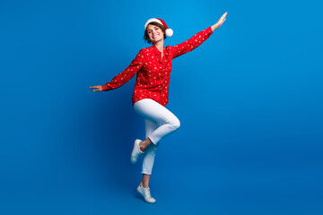 Wall Mural - Full body portrait of nice young girl enjoy dancing xmas new year holiday isolated on blue color background