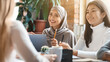 © Prostock-studio - Asian girl and lady in hijab smiling during business meeting in office, close up