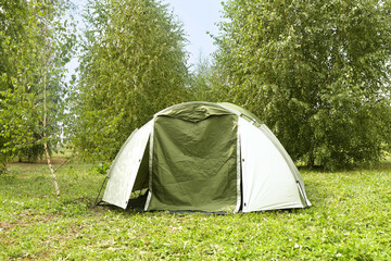 one camping tent on green grass outdoors