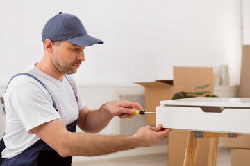 Fototapete - Handyman Assembling Table And Furniture Unpacking And Furnishing Flat After Renovation Working Indoors. Copy Space