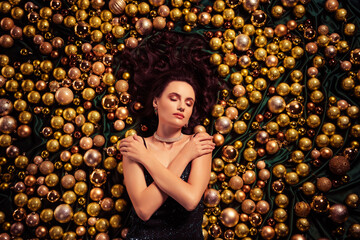 Top view photo of stunning gorgeous lady lying on x mas tree toys balls self embrace dreaming wear luxury dress