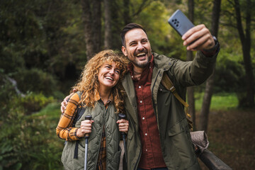 husband and wife hiker take a self portrait or video call on hiking