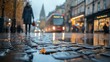 © MaMaKe - A low angle view of a wet cobblestone street in a city with a woman walking in the distance.