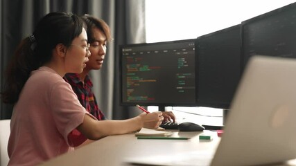 Slow motion back end software developer engineer for computer programming working together on debugging writing computing code, solving complex algorithms display on monitor in office. Burgeoning