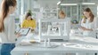 © AprilSunday - A bright, modern workspace features women collaborating on projects, using tablets and a 3D printer, showcasing creativity and innovation in design.