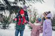 © deagreez - Photo of positive cheerful husband wife small kids wear windbreakers choosing xmas tree outside urban city park