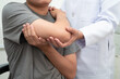 © manassanant - Physical therapy, Asian therapist doctor treat perform pain young man in hospital.