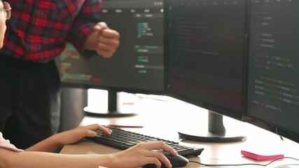 Slow motion back end or software developer manager supervising his team on new application program development on debugging and solving complex code algorithms on monitor. Burgeoning