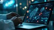 © Hardy - Digital health tools open on doctors laptop at desk