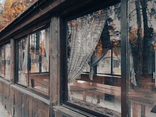 Wall Mural - A wooden building with a lot of windows and a porch