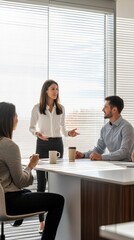 Aufkleber - A woman is giving a presentation to two men in a conference room