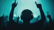 © Intelligent Horizons - Silhouetted figure of a DJ with hands raised  hyping up an enthusiastic crowd on the dance floor at a lively music event or festival  The deep depth of field creates a dynamic  vibrant atmosphere