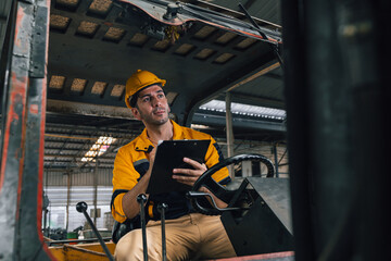 Caucasian engineer using a laptop in a factory. man working in plastics factory.